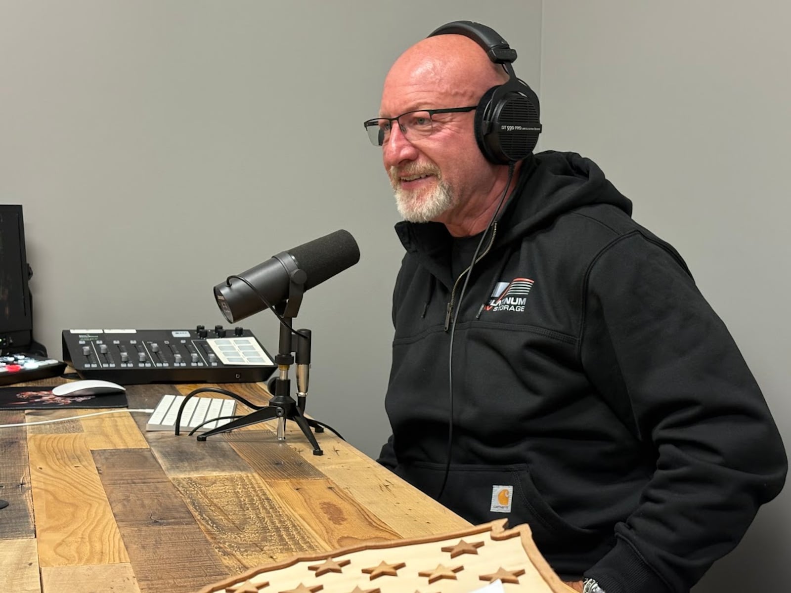 Greg McAfee in the podcast studio he built as part of his Platinum RV Storage complex in New Carlisle. THOMAS GNAU/STAFF
