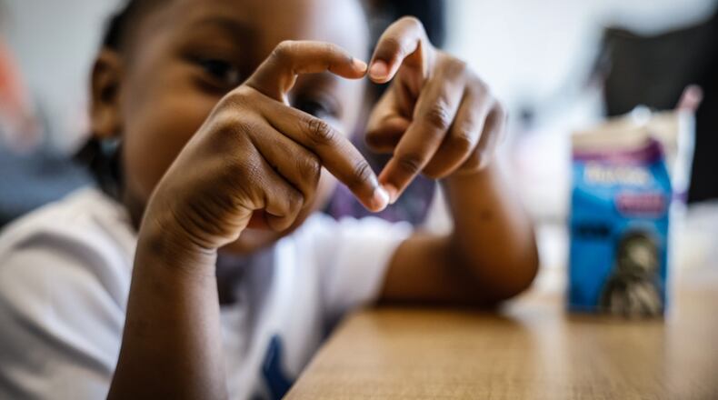 Tavion Mays II eats his lunch at the Northwest Dayton Library on Philadelphia Drive in Dayton Monday June 2, 2024. Local libraries are trying to prevent the "summer slide." JIM NOELKER/STAFF