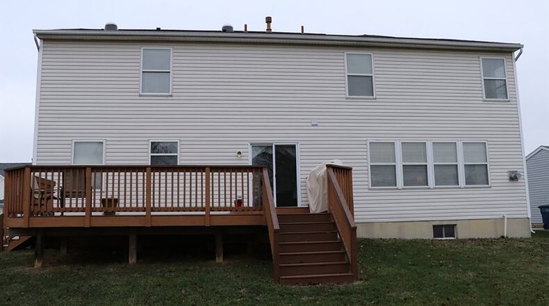 Patio doors off the breakfast room open to a wooden deck and deep back yard with no rear neighbors.