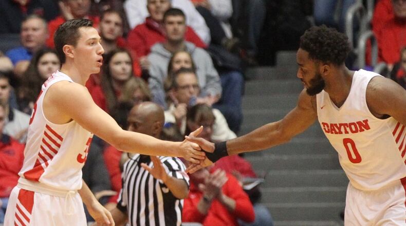 Dayton’s Ryan Mikesell and Josh Cunningham slap hands after a stop against Western Michigan on Wednesday, Dec. 19, 2018, at UD Arena. David Jablonski/Staff