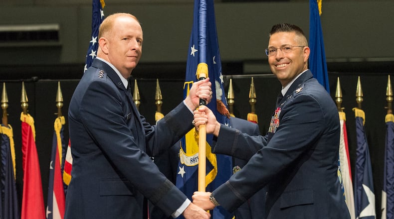 Lt. Gen. Robert McMurry (left), Air Force Life Cycle Management Center commander, passes the guidon to Col. Thomas Sherman, as Sherman assumes command of the 88th Air Base Wing during a ceremony inside the National Museum of the U. S. Air Force at Wright-Patterson Air Force Base, June 19. Sherman replaced Col. Bradley McDonald. (U.S. Air Force photo/Wesley Farnsworth)