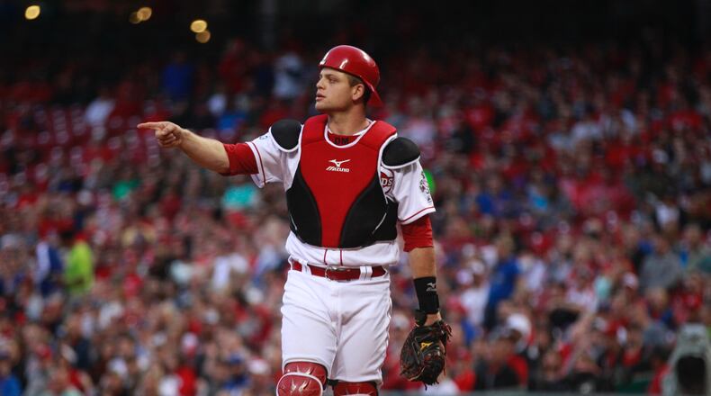 The Cubs’ Javier Baez lies on the ground after scoring on a hard slide against Reds catcher Devin Mesoraco on Friday, April 22, 2016, at Great American Ball Park in Cincinnati. David Jablonski/Staff
