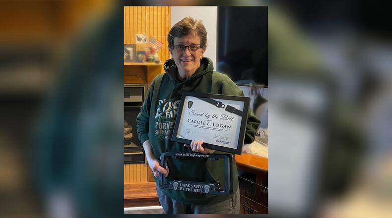 Carole Logan received a Saved by the Belt certificate and license plate bracket by the Ohio State Highway Patrol on Thursday, Dec. 28, 2023. She was recognized as part of a joint effort between OSHP and the Ohio Department of Public Safety acknowledging people who benefited from wearing a seat belt. Photo courtesy the Ohio State Highway Patrol.