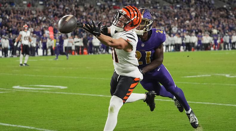 Cincinnati Bengals wide receiver Jermaine Burton (81) reaches for an incomplete pass as Baltimore Ravens cornerback Brandon Stephens (21) defends during the second half of an NFL football game, Thursday, Nov. 7, 2024, in Baltimore. (AP Photo/Stephanie Scarbrough)