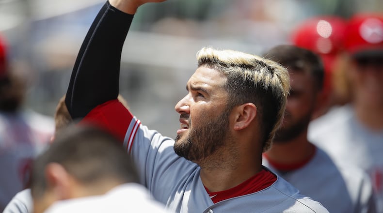 ATLANTA, GA - JUNE 27: Eugenio Suarez #7 of the Cincinnati Reds celebrates with teammates after scoring in the seventh inning of an MLB game against the Atlanta Braves at SunTrust Park on June 27, 2018 in Atlanta, Georgia. (Photo by Todd Kirkland/Getty Images)