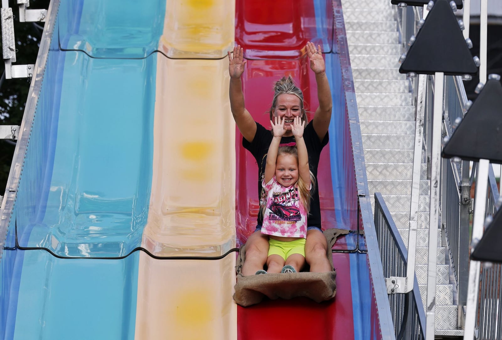Kaylin Bryant and daughter, Stormi, 4, ride the Fun Slide at the Butler County Fair Thursday, July 25, 2024 in Hamilton. NICK GRAHAM/STAFF