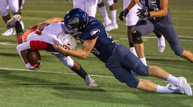 Fairmont linebacker Tyler Adkins tackles Trotwood quarterback Timothy Carpenter in the Firebirds' 35-0 win in Week 2. The Firebirds are limiting opponents to an average of 67 yards rushing. Jeff Gilbert/CONTRIBUTED