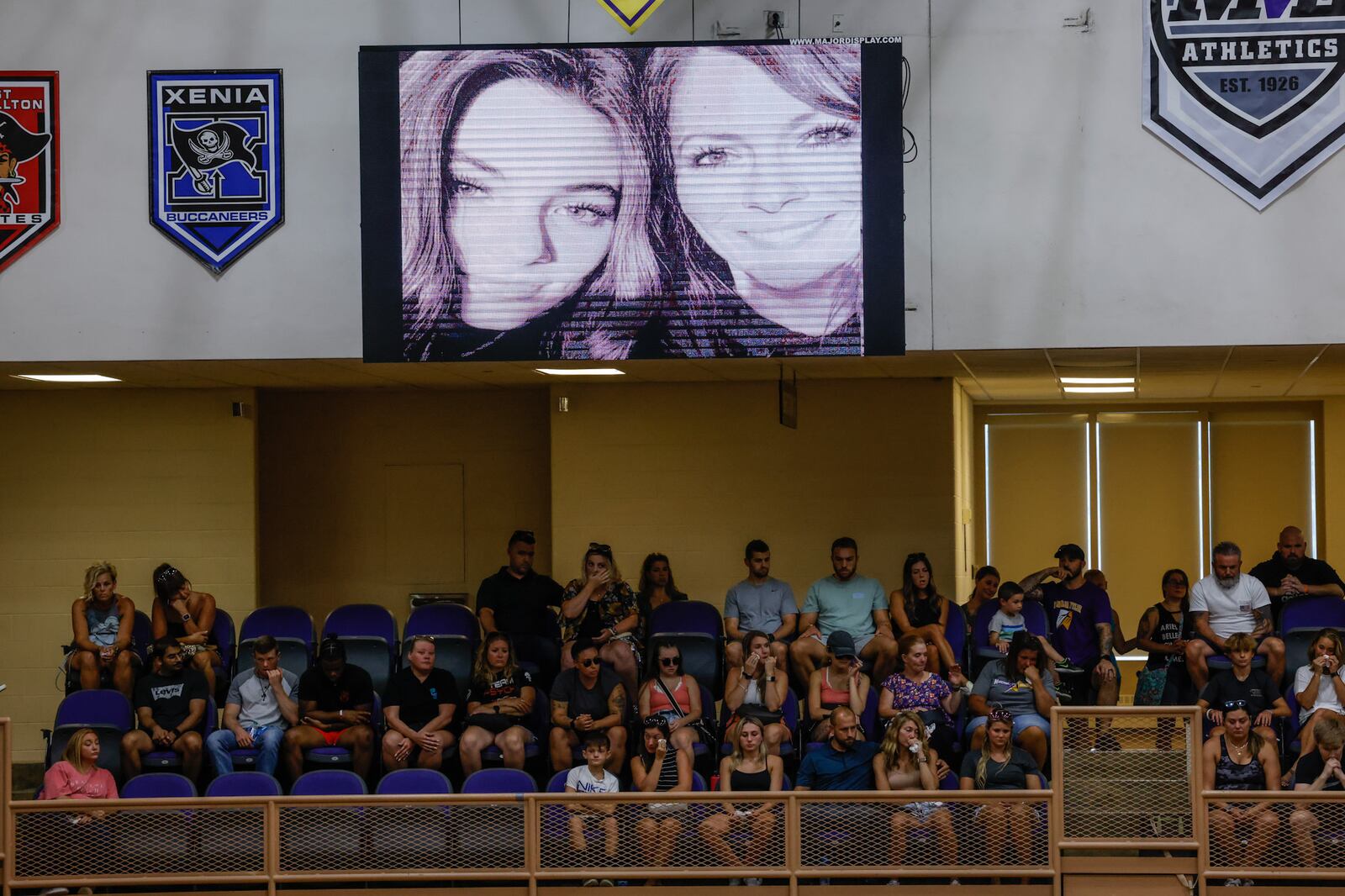 A photo of mother-daughter Kayla, 15, and Sarah, 41, Anderson who both lost their lives in the Butler Twp. shooting was displayed in the gym during the vigil Monday evening, Aug. 8, 2022, held at Butler High School. Also killed Friday morning on Hardwicke Place were neighbors Clyde and Eva "Sally" Knox. JIM NOELKER/STAFF