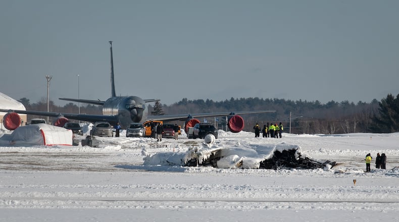 Investigators from the Federal Aviation Administration and National Transportation Safety Board investigate a plane crash at Bangor International Airport Wednesday, Jan. 28, 2026 in Bangor, Maine. (Linda Coan O'Kresik/The Bangor Daily News via AP)