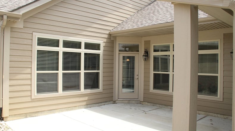 The courtyard patio design creates total privacy and requires little maintenance. The main part of the patio extends to a “T” shape with privacy fencing at one end and a gate at the other end.