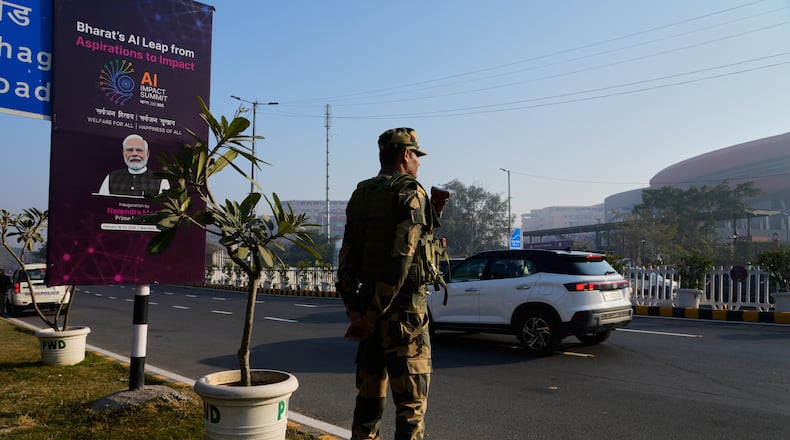 An Indian para-military force soldier stands guard outside the venue of AI-Summit in New Delhi, India, Monday, Feb. 16, 2026. (AP Photo/Manish Swarup)