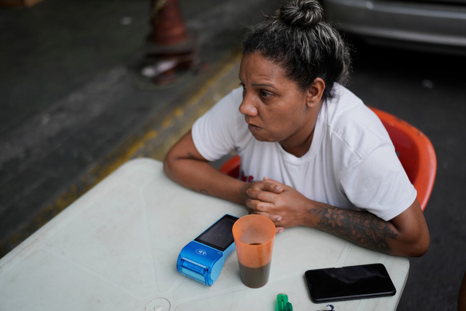 A street food vendor waits for patrons in Caracas, Venezuela, Thursday, April 10, 2025. (AP Photo/Ariana Cubillos)