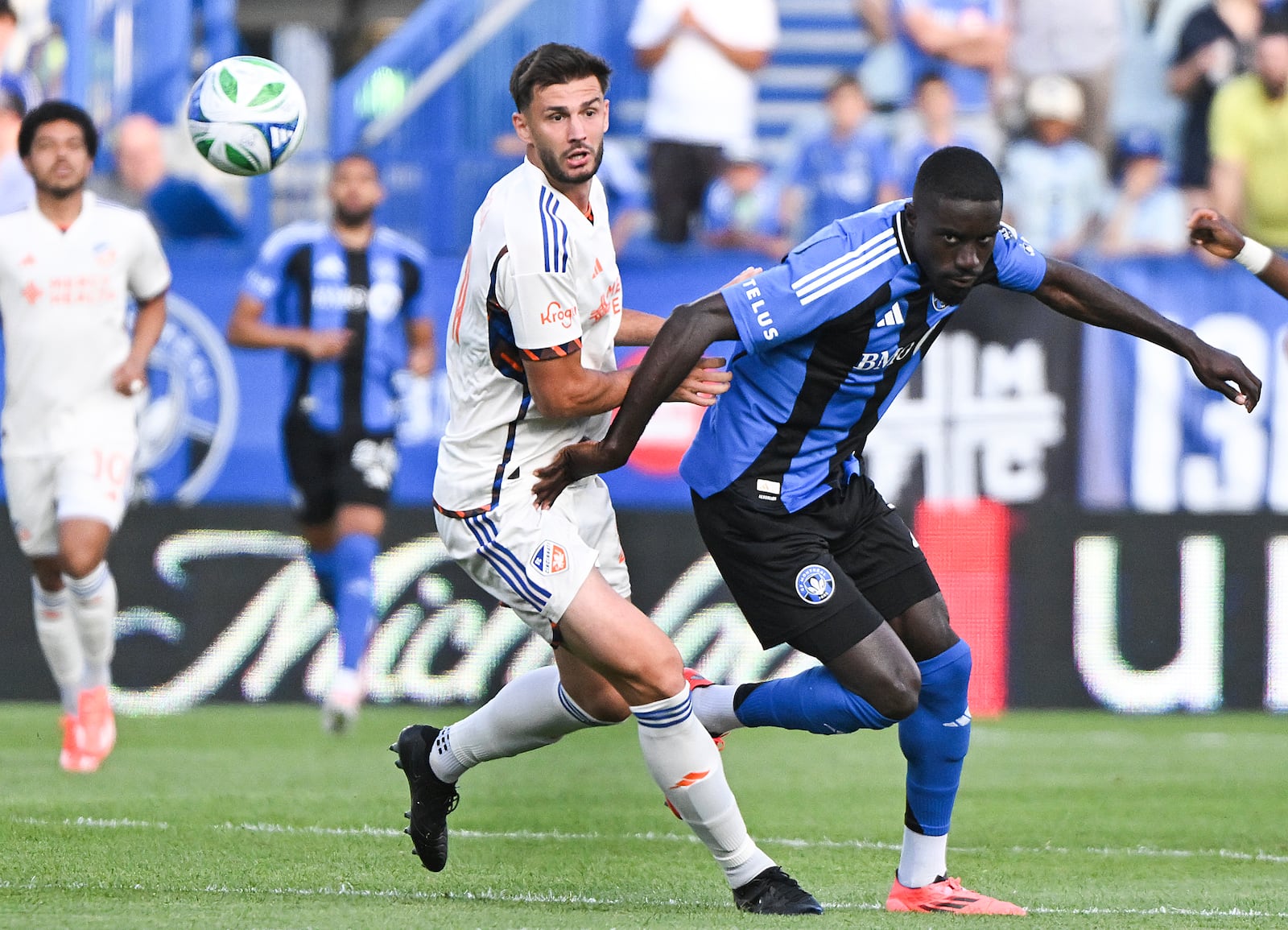 CF Montreal's Prince Owusu, right, tries to get by FC Cincinnati's Matt Miazga (21) during the first half of an MLS soccer match in Montreal, Wednesday, June 25, 2025. (Graham Hughes/The Canadian Press via AP)
