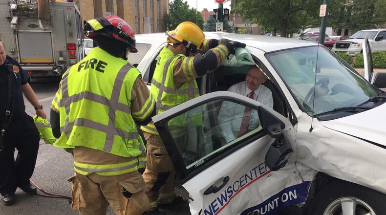 Jim Otte is helped out of a News Center 7 sports utility vehicle Friday morning. STAFF