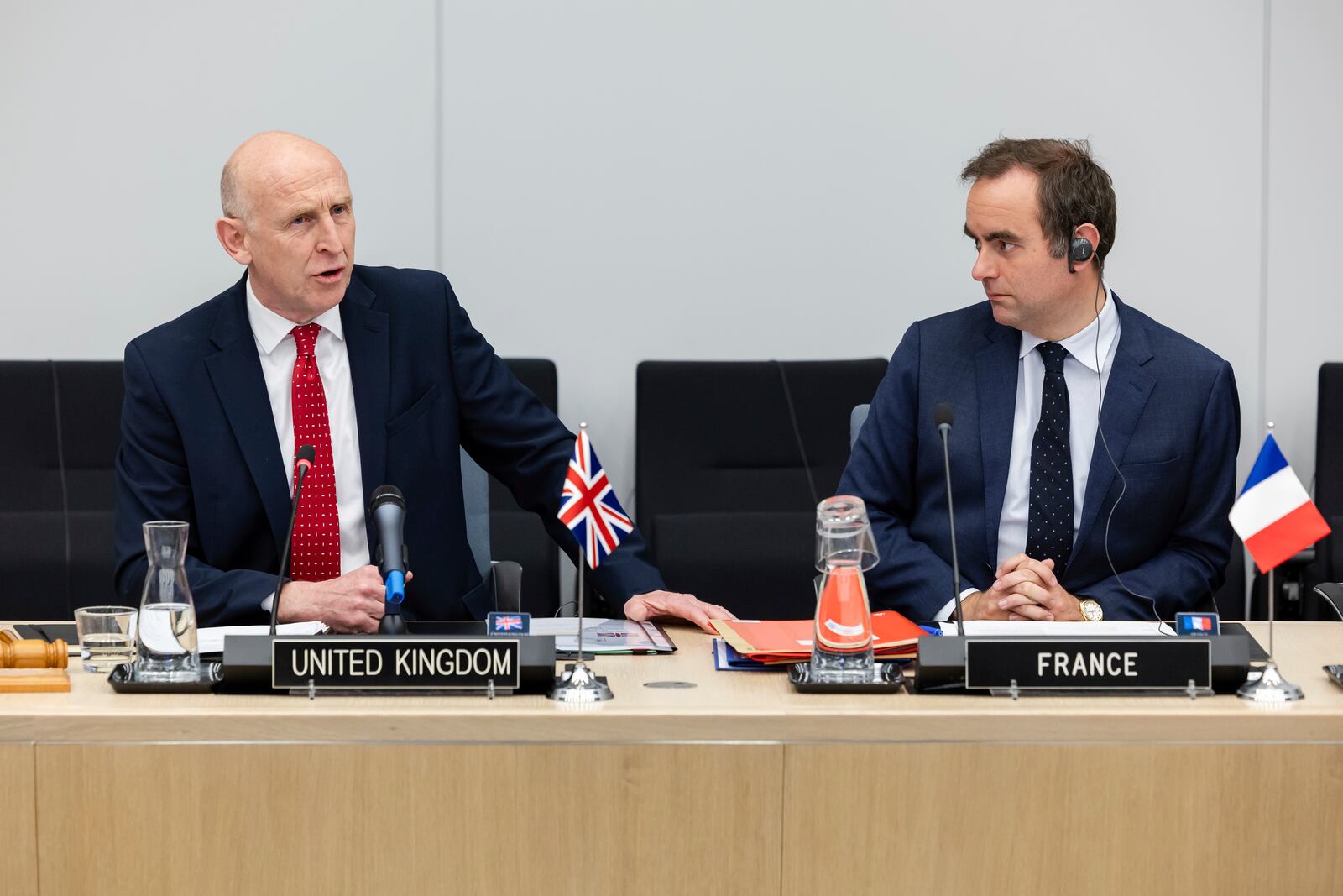 Britain's Defense Secretary John Healey, left, sits next to French Defense Minister Sebastien Lecornu as he talks during a coalition of the willing defence ministers meeting at NATO headquarters in Brussels, Belgium, Thursday, April 10, 2025. (AP Photo/Geert Vanden Wijngaert)