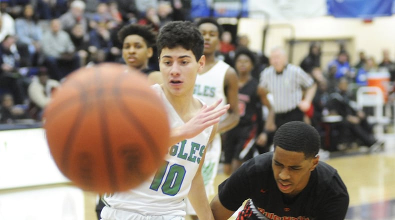 CJ’s Jack Nauseef (left) chases a loose ball during a 60-59 defeat of Akron Buchtel in Flyin’ to the Hoop. MARC PENDLETON / STAFF