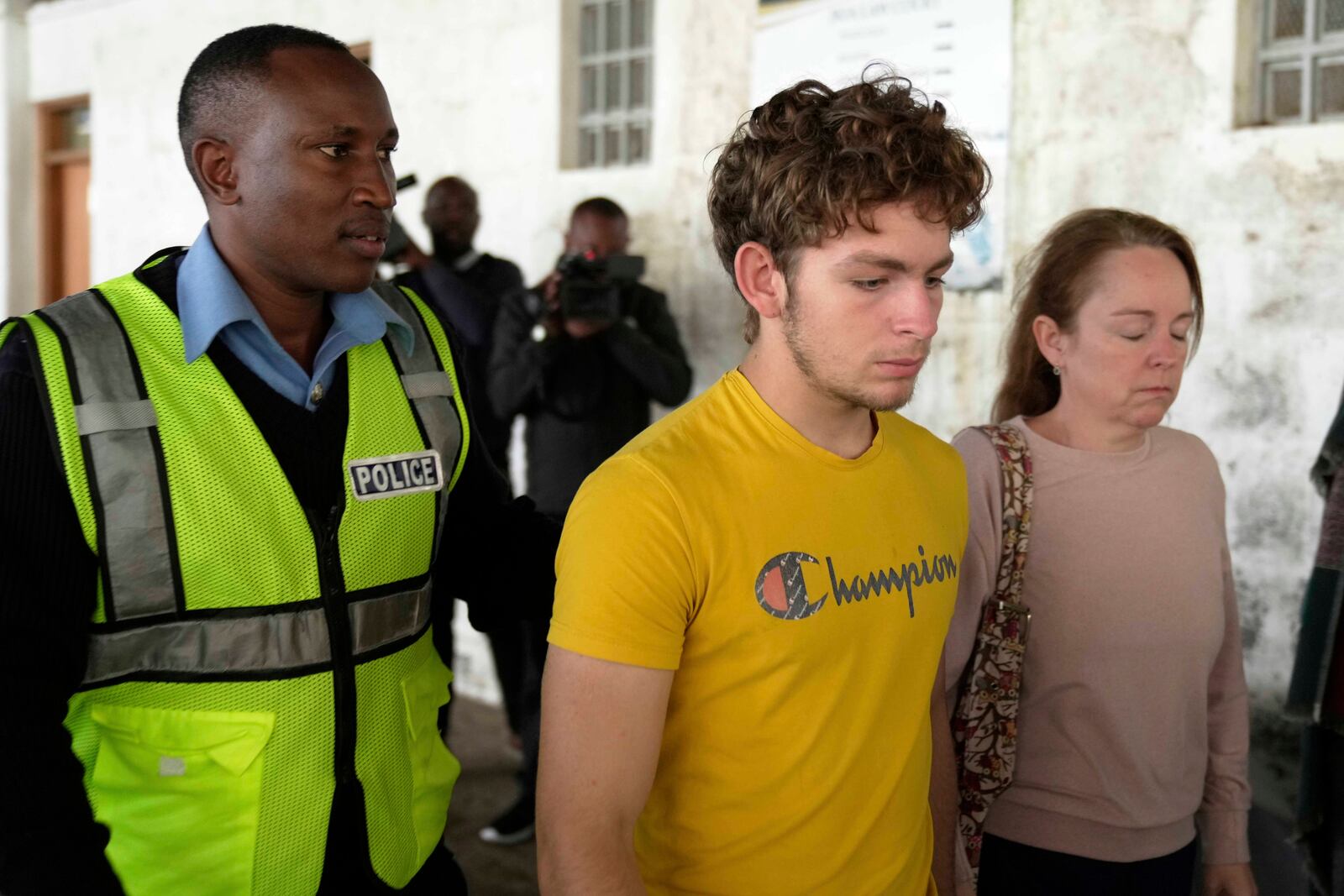 Belgian national Lornoy David, center, who admitted to charges related to the illegal possession and trafficking of live queen ants to sell as exotic pets, walks out of the Jomo Kenyatta International Airport Law Courts in Nairobi, Kenya Wednesday, April 23, 2025. (AP Photo/Brian Inganga)