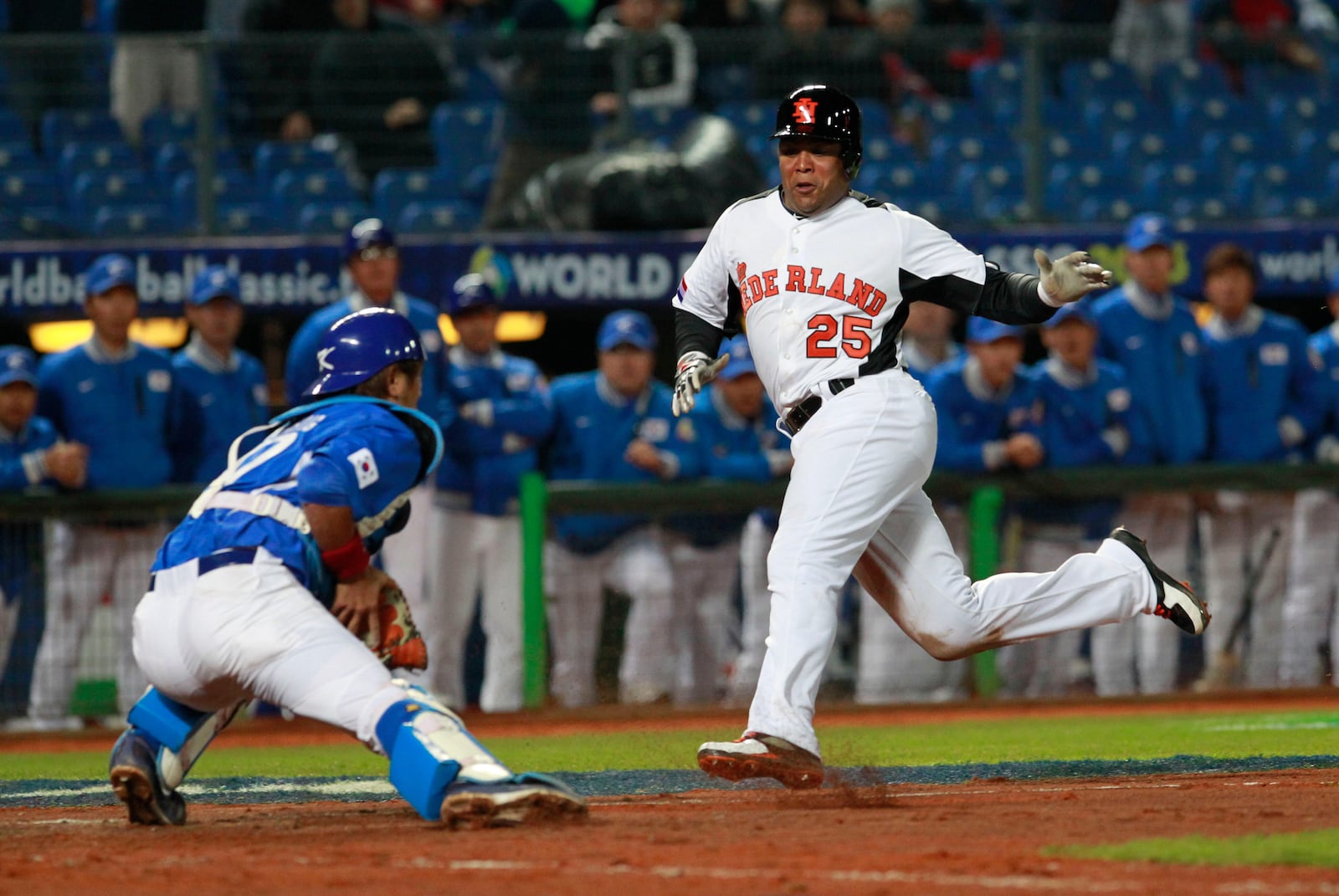 FILE - The Netherlands' designated hitter Andruw Jones (25) tries to dodge Korea's catcher Kang Minho (47) on home plate in the fourth inning of a World Baseball Classic first-round game at the Intercontinental Baseball Stadium in Taichung, Taiwan, March 2, 2013. (AP Photo/Wally Santana, File)
