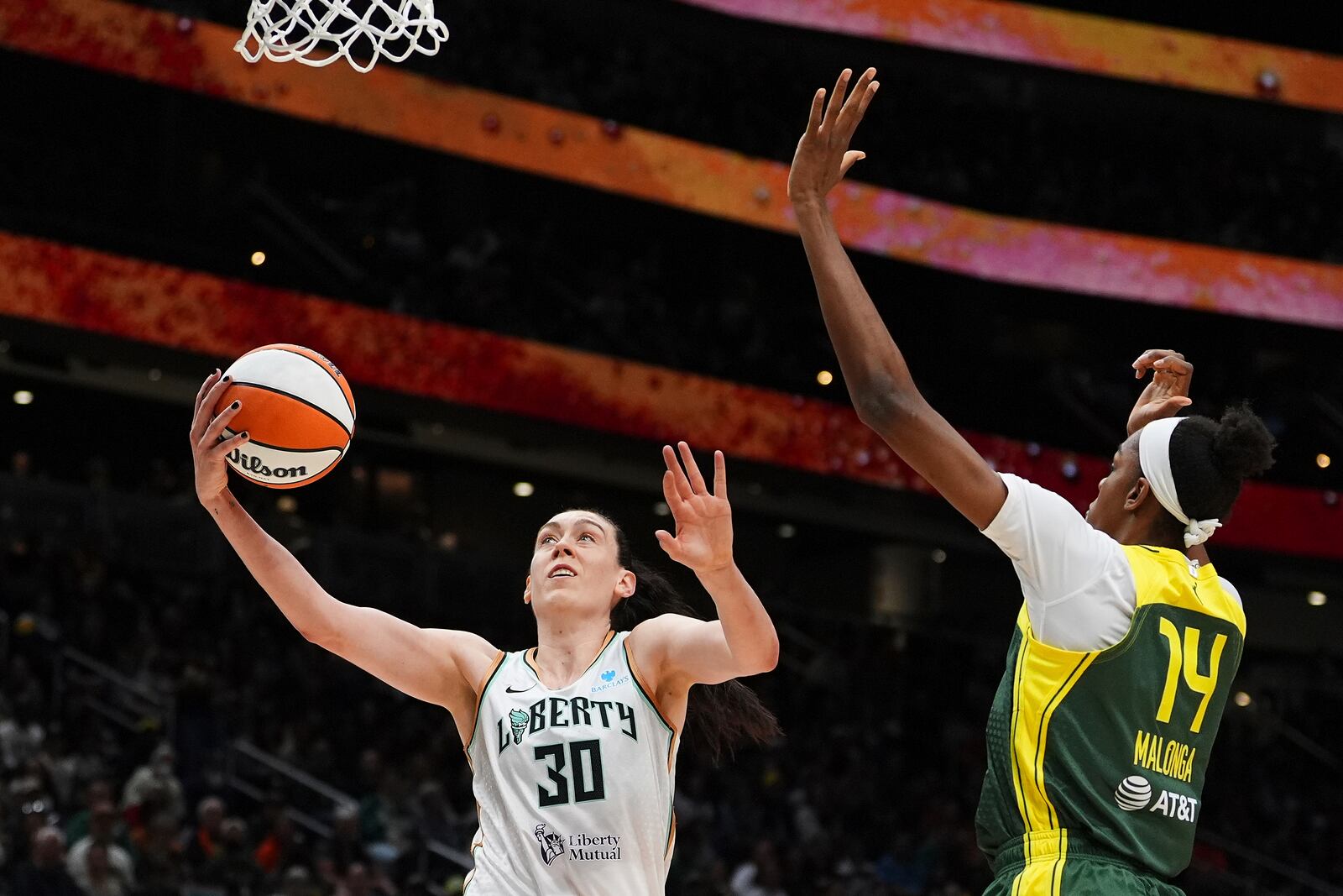 New York Liberty forward Breanna Stewart (30) goes to the basket against Seattle Storm center Dominique Malonga (14) during the first half of a WNBA basketball game Sunday, June 22, 2025, in Seattle. (AP Photo/Lindsey Wasson)