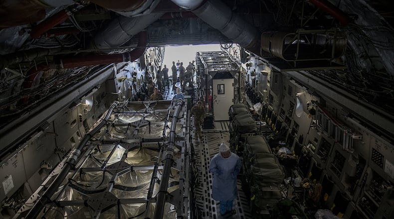 Flight nurses and critical care air transport team members assigned to the 43rd Aeromedical Evacuation Squadron from Pope Army Air Field, N.C., and 375th AES from Scott Air Force Base, Ill., prepare a Transport Isolation System for simulated Ebola patients during a TIS training exercise at Joint Base Charleston, S.C., Oct. 23, 2019. The TIS is a device used to transport Ebola patients, either by C-17 Globemaster III or C-130 Hercules, while preventing the spread of disease to medical personnel and aircrews until the patient can get to one of three designated hospitals in the United States that can treat Ebola patients. (U.S. Air Force photo)