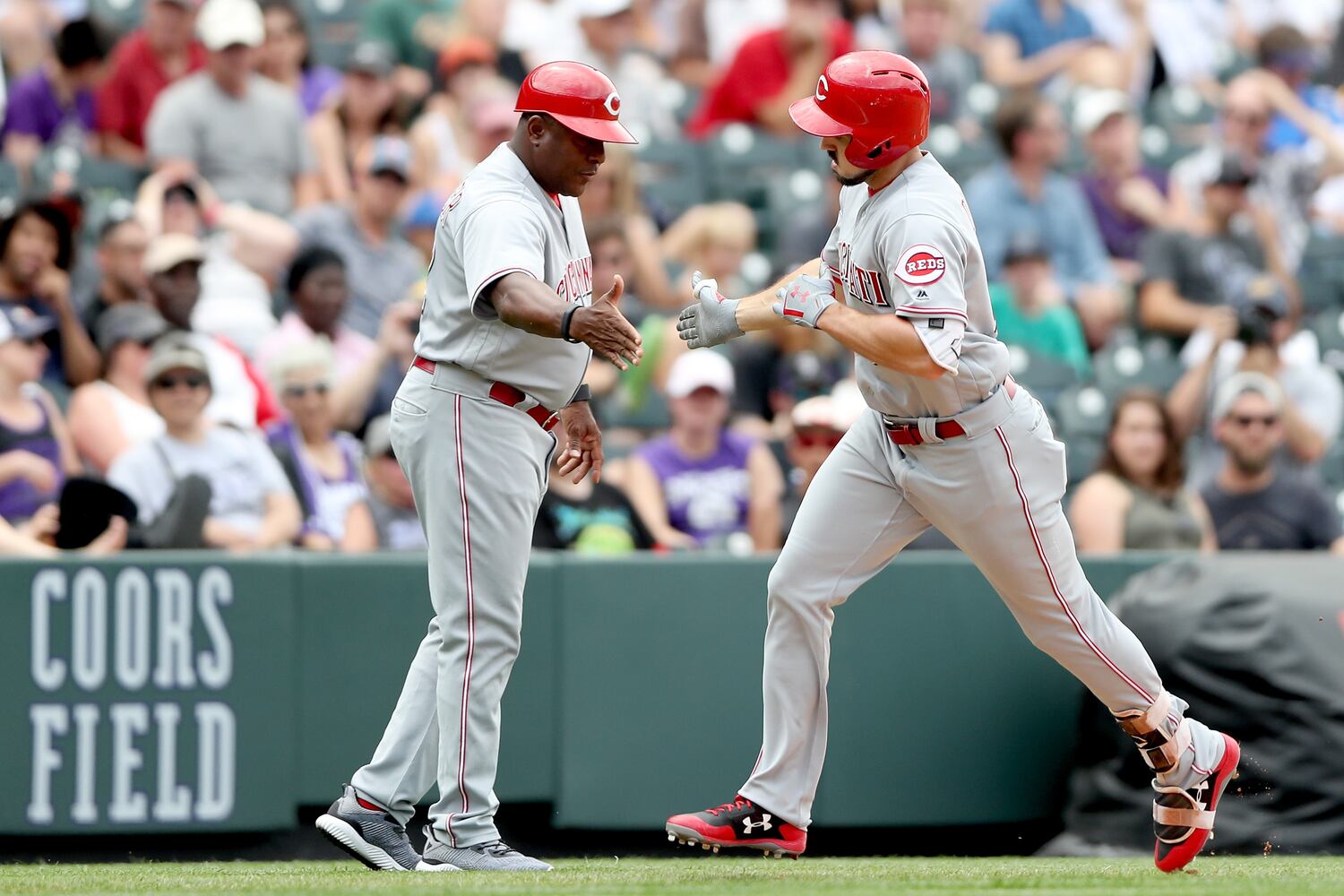 PHOTOS: Reds pile up 13 hits, beat the Rockies