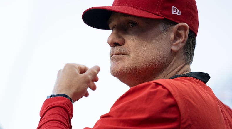 Cincinnati Reds manager David Bell stands in the dugout during the seventh inning of the team's baseball game against the Washington Nationals on Friday, June 3, 2022, in Cincinnati. (AP Photo/Jeff Dean)