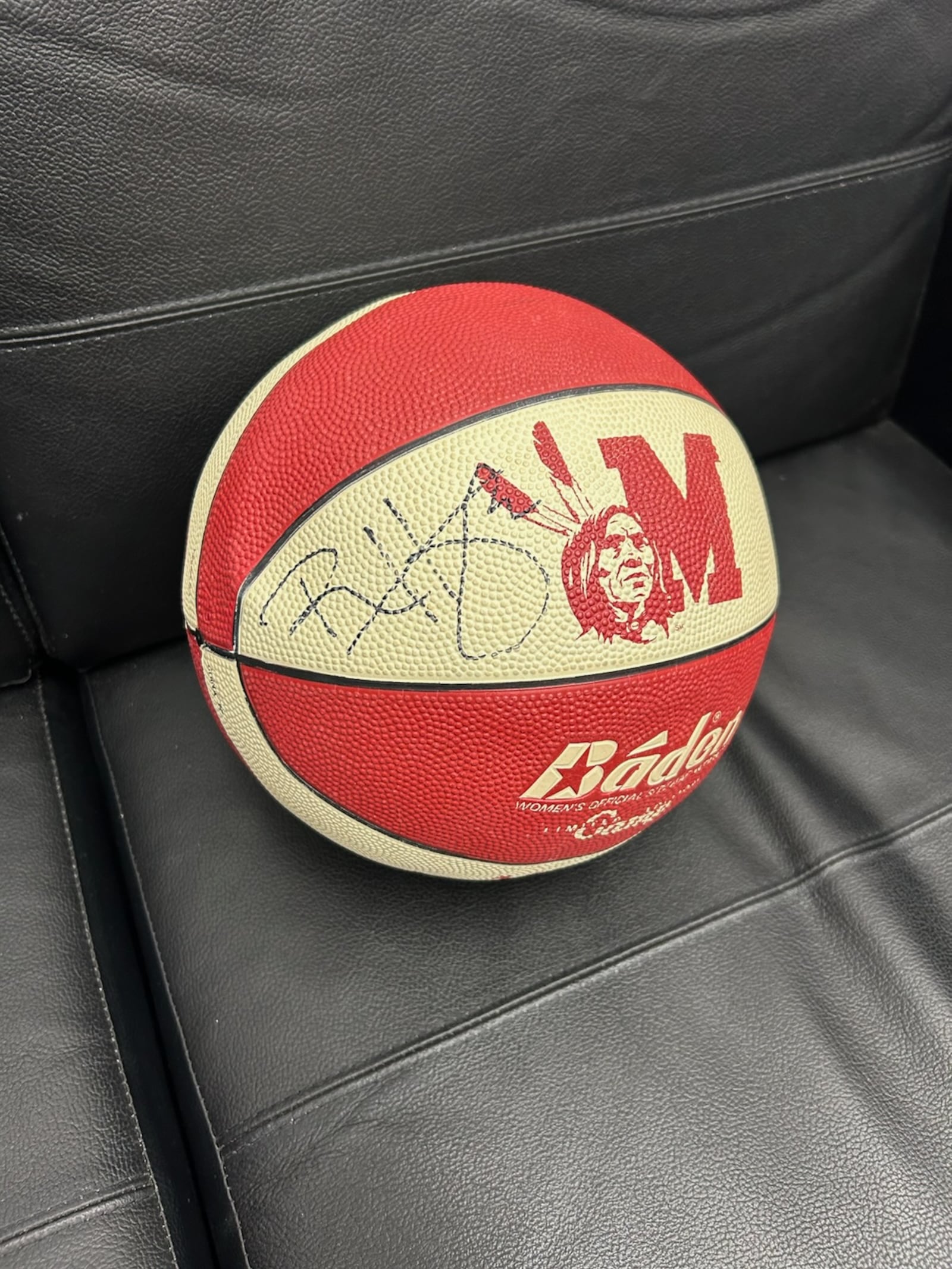 Miami University athletic director David Sayler keeps an old Miami basketball in his office. He attended a Miami basketball camp as a child and the ball was signed by Ron Harper. CONTRIBUTED PHOTO