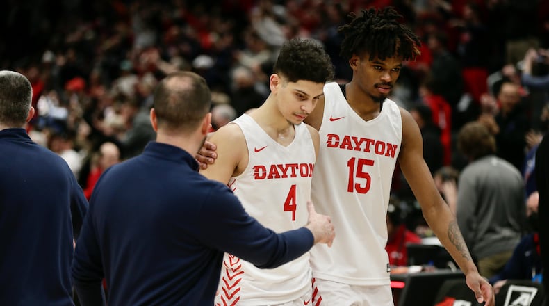 Dayton's Koby Brea and DaRon Holmes II leave the court after a loss to Richmond in the semifinals of the Atlantic 10 Conference tournament on Saturday, March 12, 2022, at Capital One Arena in Washington, D.C. David Jablonski/Staff