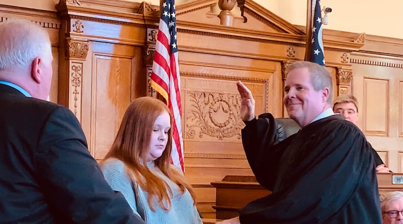 David McNamee is sworn in as Xenia Municipal Court Judge by his brother Michael  McNamee, with the Bible held by his daughter Sarah McNamee. LONDON BISHOP/STAFF