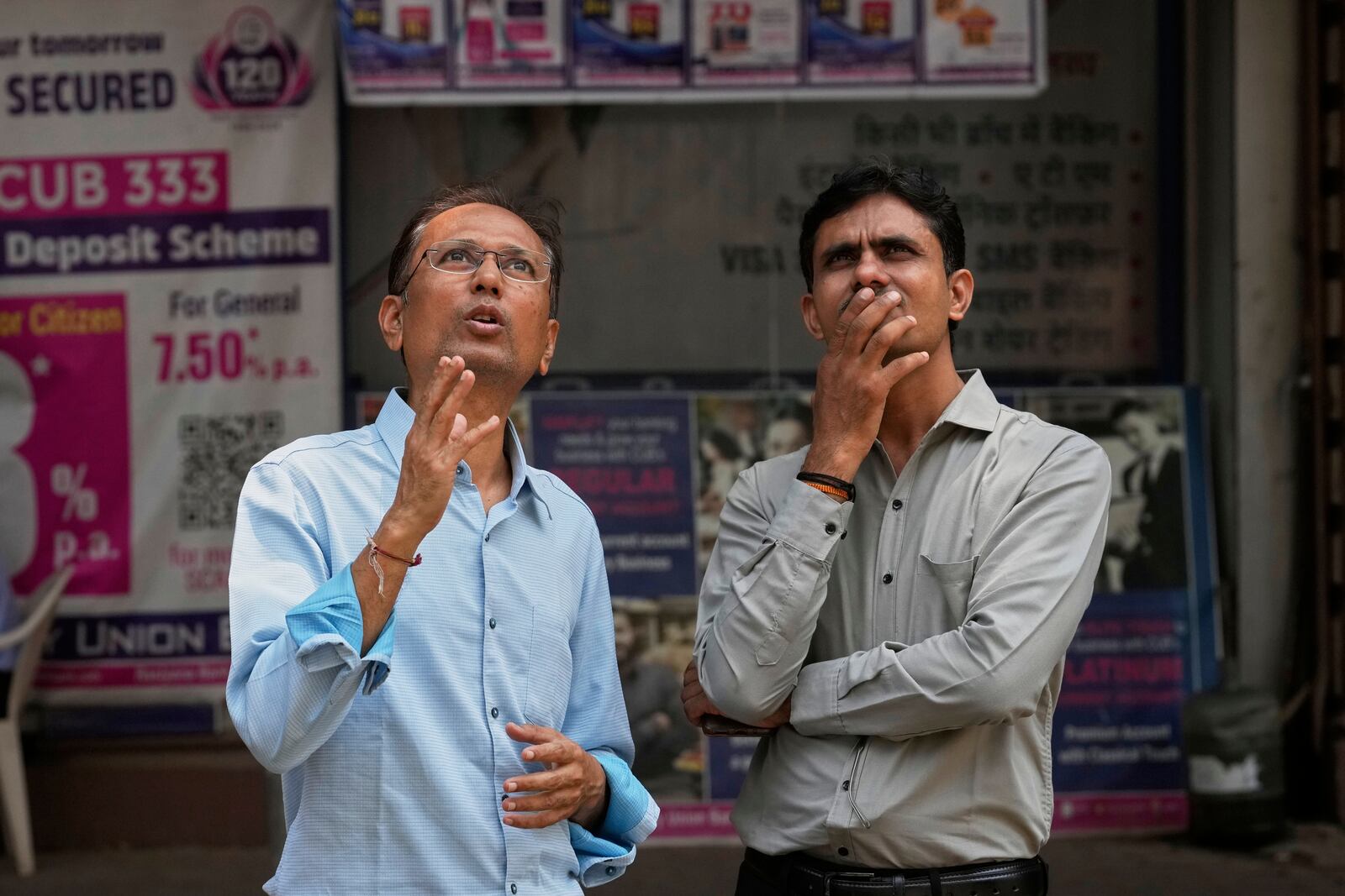 People watch a live screen on the facade of Bombay Stock Exchange (BSE) building in Mumbai, India, Monday, April 7, 2025. (AP Photo/Rajanish Kakade)