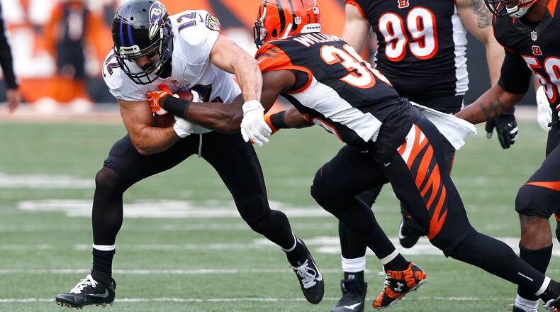 Michael Campanaro of the Ravens is tackled by Bengals strong safety Shawn Williams in the last game of the 2016 season, a 27-10 Cincinnati win in Paul Brown Stadium.