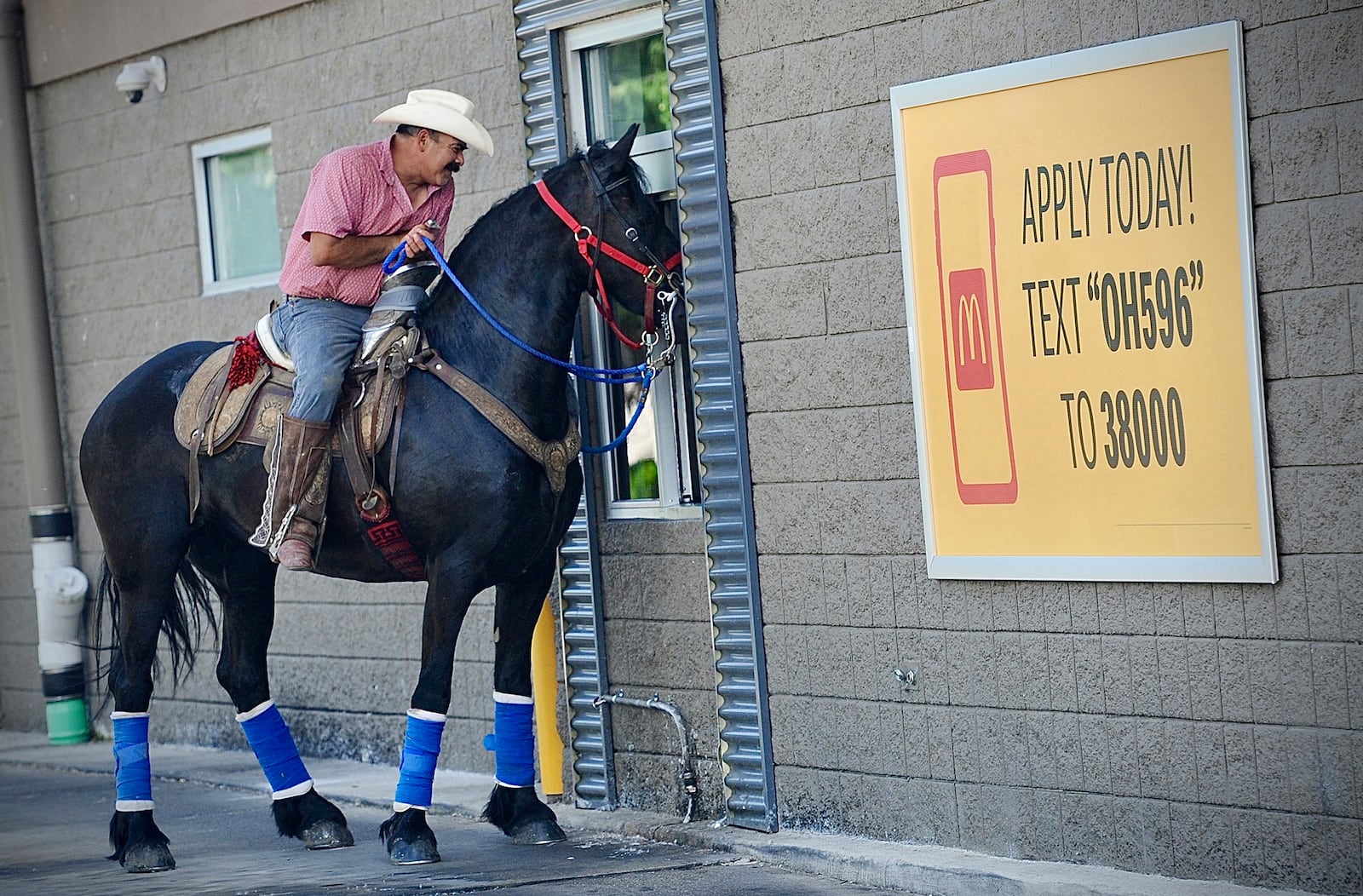 Ramón Martinez Prieto on his horse Nikki goes through the drive-thru at the McDonald’s in Enon on Saturday, May 25, 2024, to pick up some lunch. 