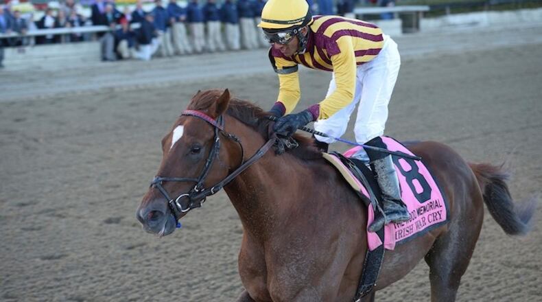 In this photo provided by Coglianese Photos, Rajiv Maragh rides Irish War Cry to victory in the Wood Memorial horse race at Aqueduct Racetrack in New York. Irish War Cry is one of 20 horses vying to wear the garland of red roses. (Chelsea Durand/Coglianese Photos via AP)