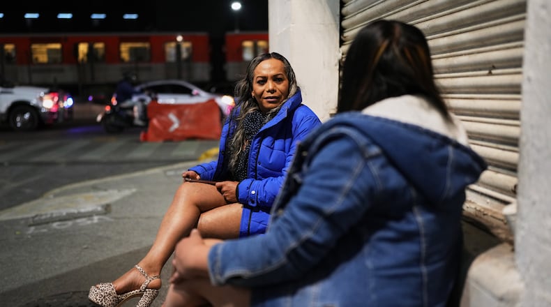 Montserrat Fuentes, left, speaks with a fellow sex worker on Calzada de Tlalpan where she has worked for 20 years and the city is building a bike lane that blocks cars from pulling over and closes the metro at night, in Mexico City, Friday, Jan. 30, 2026. (AP Photo/Eduardo Verdugo)