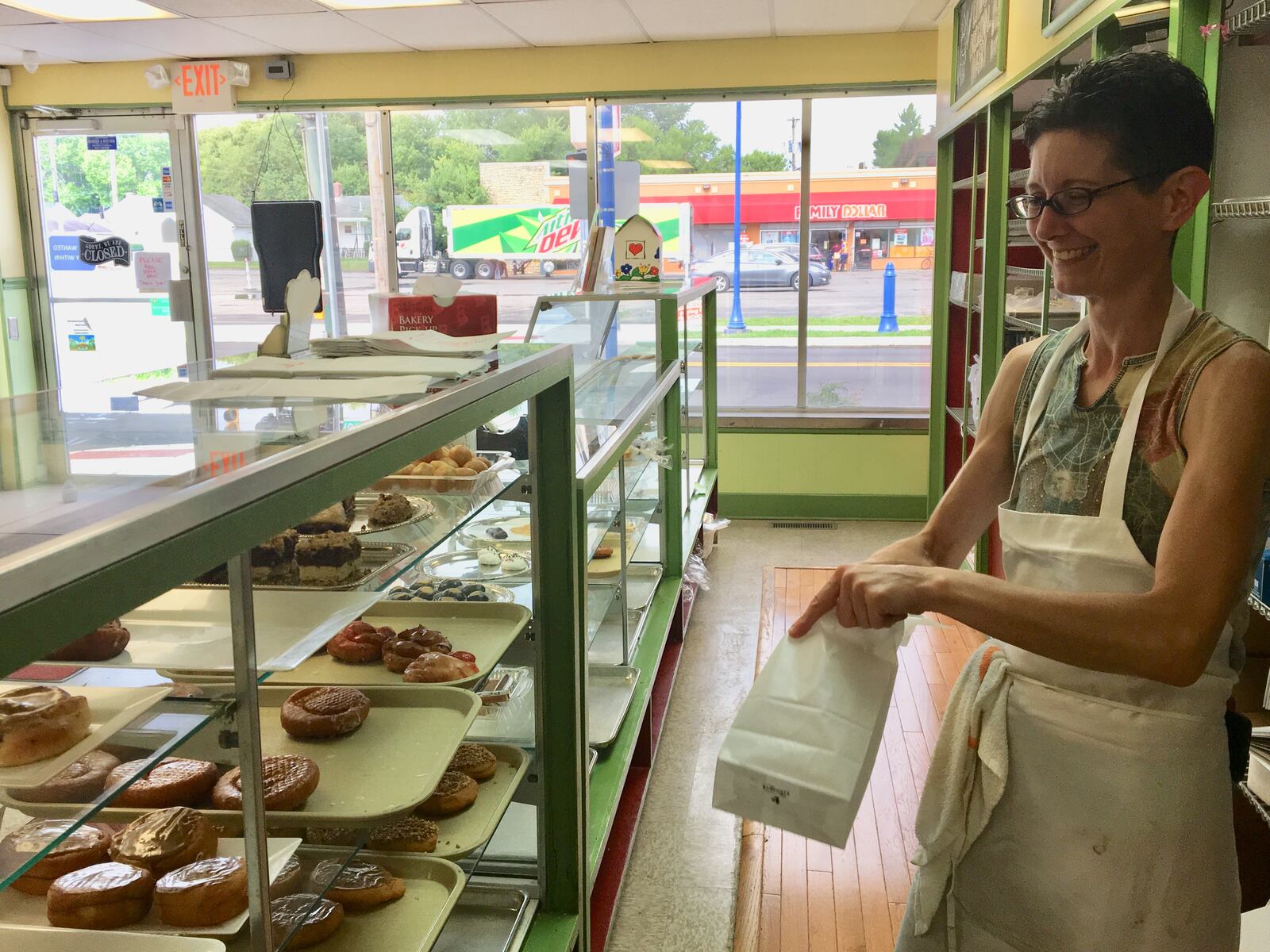 Jennifer Evans works in her family bakery in Old North Dayton. The business has hired individuals in recovery who live at Good Shepherd Ministries sober living homes. KATIE WEDELL/STAFF