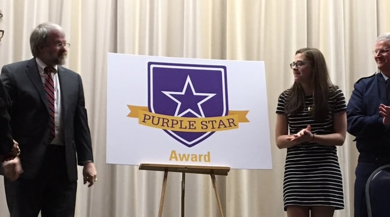 Paolo DeMaria, state superintendent for public instruction (left), and Zuza Livosky, then a Fairborn High School junior, unveiled the new Purple Star Award in 2017 at the National Museum of the U.S. Air Force. At far right is Maj. Gen. Mark E. Bartman, Ohio adjutant general. BARRIE BARBER/STAFF