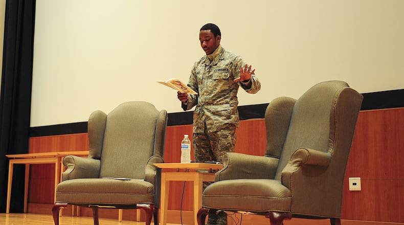 Senior Airman Yahel Pack, a geospatial analyst working in the National Air and Space Intelligence Center, performs his poetry in the NASIC auditorium before his peers. (U.S. Air Force photo/Senior Airman Samuel Earick)