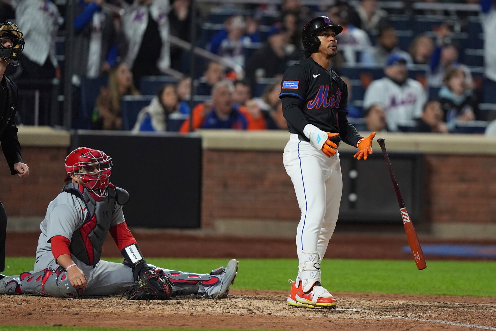 St. Louis Cardinals catcher Pedro Pagés, left, watches as New York Mets' Francisco Lindor hits a walk-off home run during the ninth inning of a baseball game Friday, April 18, 2025, in New York. (AP Photo/Frank Franklin II)