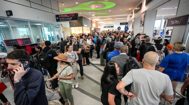 Airline passengers wait in long lines to get through the TSA security screening at William P. Hobby Airport in Houston, Sunday, March 8, 2026. (Brett Coomer/Houston Chronicle via AP)