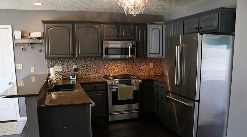 The U-shaped kitchen has painted cabinetry and granite countertops. The 2-level peninsula counter offers breakfast bar seating and work space with a double-sink and storage. There is a small pantry closet.