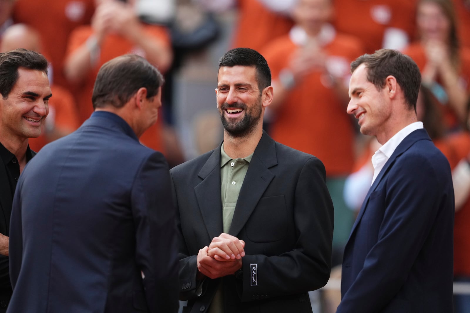 Rafa Nadal, second from left, is joined by Roger Federer, left, Novak Djokovic and Andy Murray, right, during a farewell ceremony at center court Philippe-Chatrier, at the Roland-Garros stadium, in Paris, Sunday May 25, 2025. (AP Photo/Lindsey Wasson)