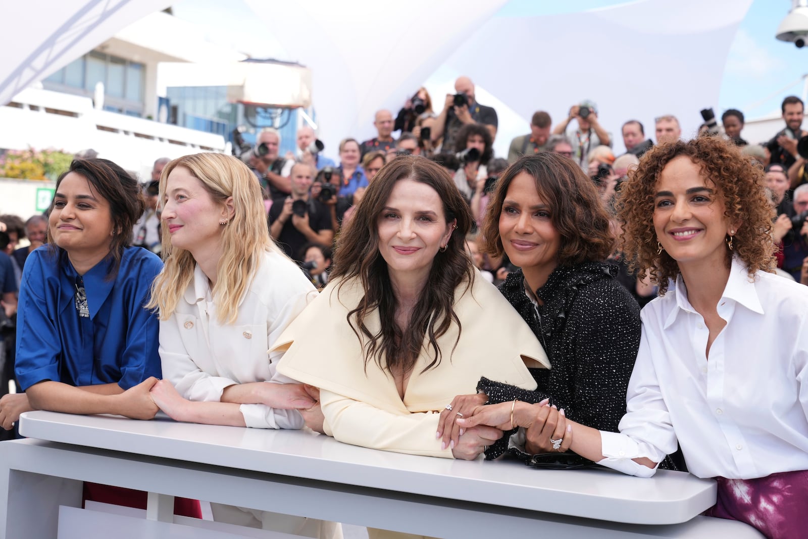 Jury president Juliette Binoche, centre, and jury members Payal Kapadia, from left, Alba Rohrwacher, Halle Berry and Leila Slimani pose for photographers at the jury photo call at the 78th international film festival, Cannes, southern France, Tuesday, May 13, 2025. (AP Photo/Natacha Pisarenko)