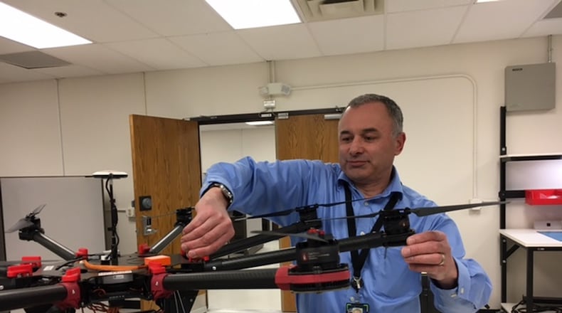 Andy Jones, senior program manager at defense contractor MacAulay-Brown Inc., adjusts one of the company’s unmanned aerial vehicles at the company’s Beavercreek’s offices. THOMAS GNAU/STAFF