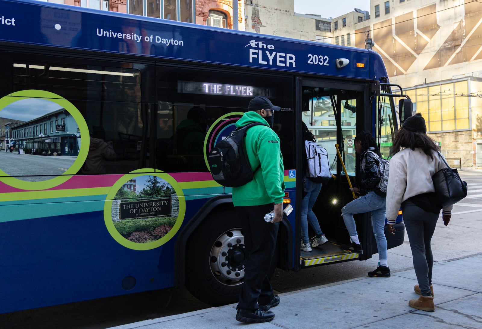 Riders step onto RTA's The Flyer on Monday, Nov. 3 near the RTA hub on Main Street in downtown Dayton. BRYANT BILLING/STAFF