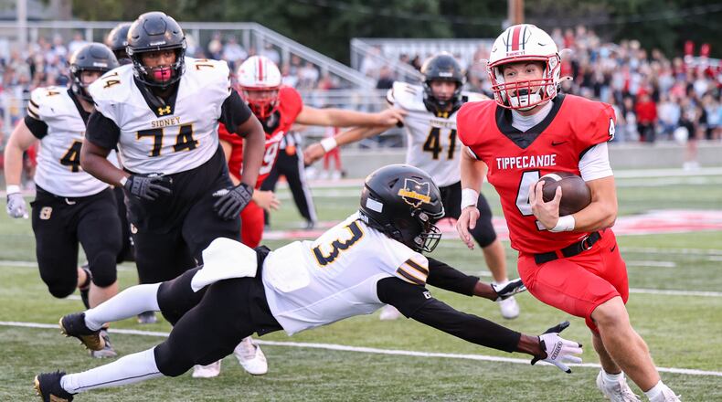 Tippecanoe junior quarterback Larkin Thomas as Sidney's Demarcuse Fleming tries to tackle during a Miami Valley League game on Thursday, Sept. 25 at Tipp City Park. BRYANT BILLING / STAFF