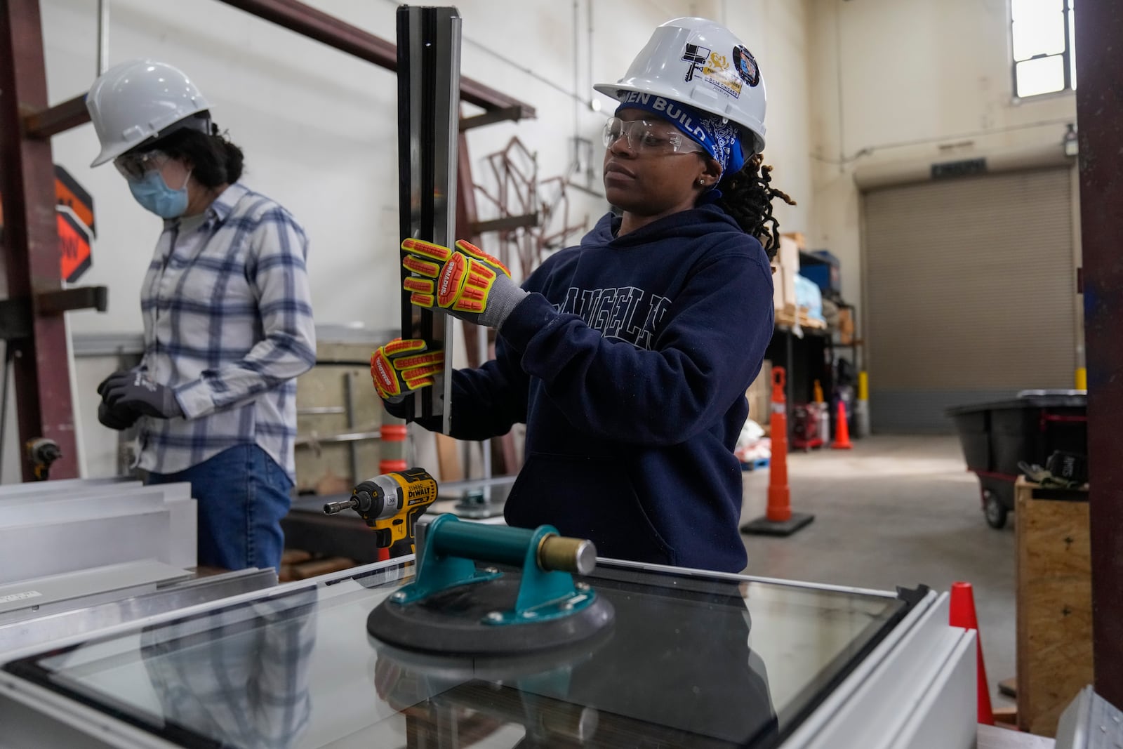 Chyanne Henderson practices putting together a window during an Ironworkers Local 63 pre-apprenticeship class Wednesday, March 26, 2025, in Broadview, Ill. (AP Photo/Erin Hooley)