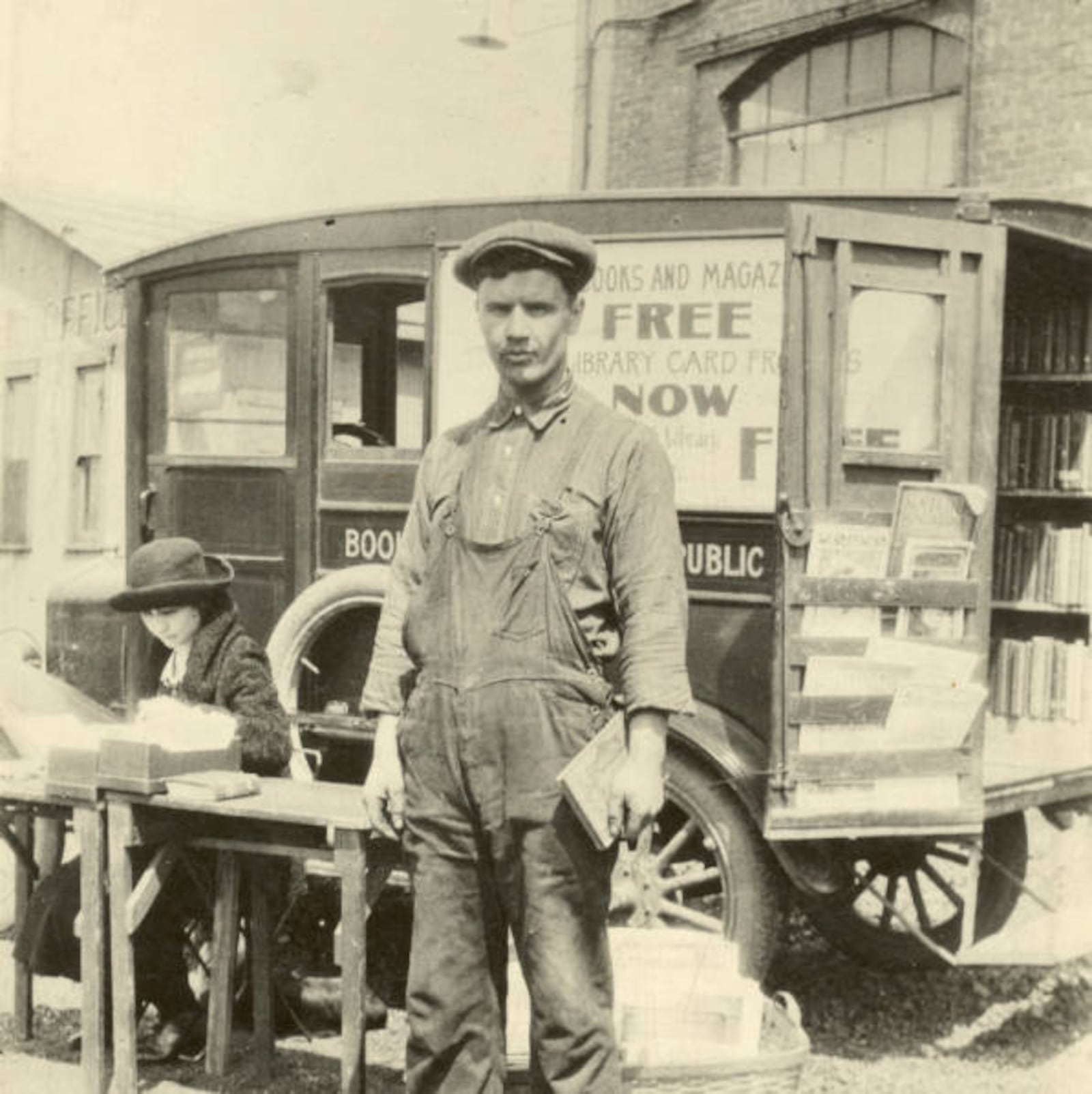 This photo shows the original motorized Dayton Metro Library Bookmobile, alongside a local factory worker, circa 1924. CONTRIBUTED