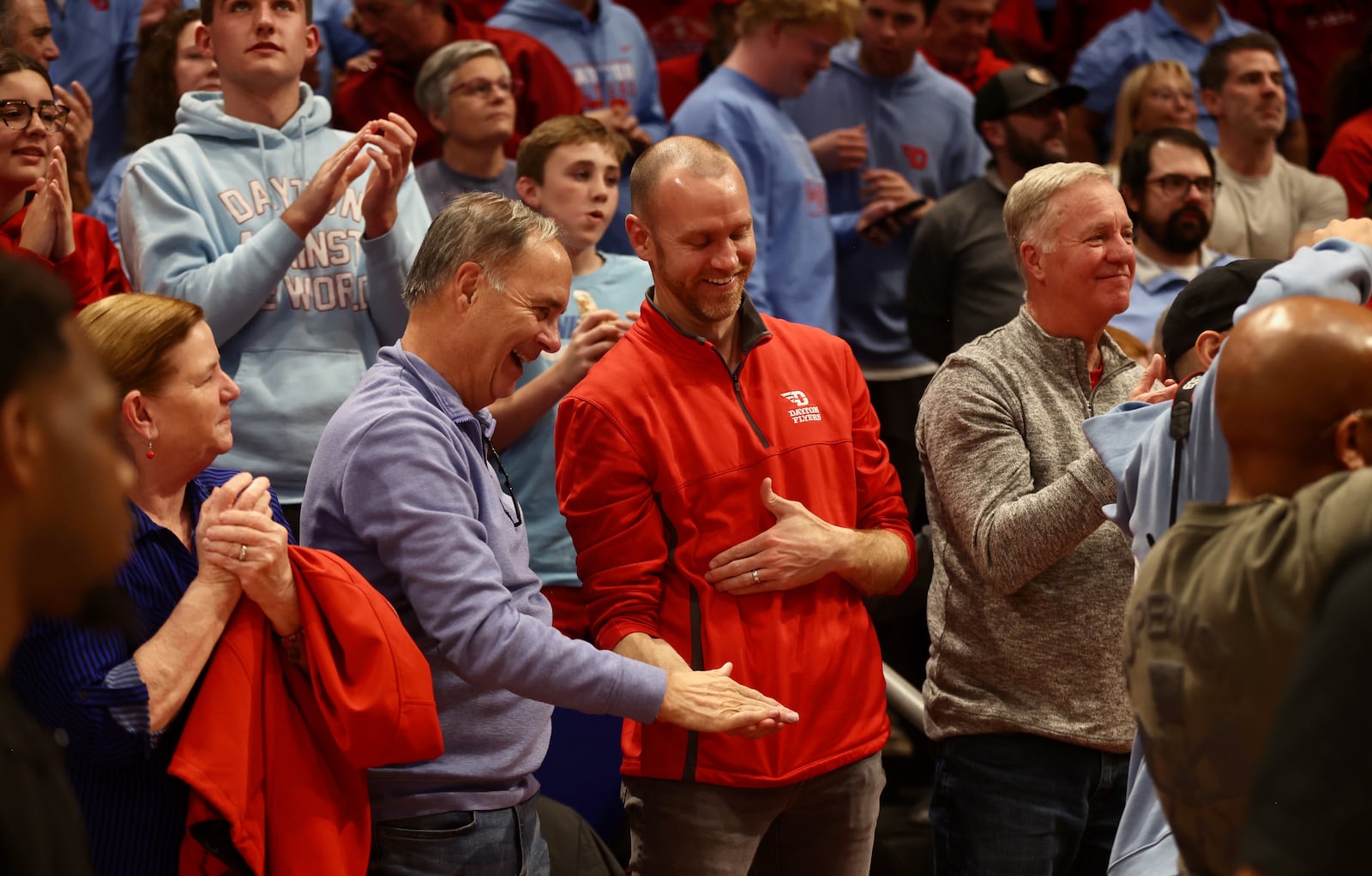 Dayton fans Pete Roll, left, and John Roll celebrate a victory against Marquette on Saturday, Dec. 14, 2024, at UD Arena. David Jablonski/Staff
