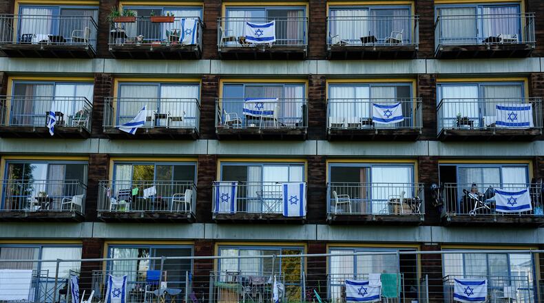 FILE - Israeli flags decorate rooms of Israelis who evacuated from cities and towns along the border with Lebanon, in kibbutz Ginosar hotel, northern Israel, Tuesday, March 5, 2024. (AP Photo/Ariel Schalit, file)
