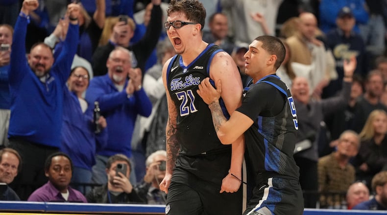 Saint Louis' Robbie Avila (21) and Ishan Sharma, right, celebrate after defeating George Washington in an NCAA college basketball game Tuesday, Jan. 27, 2026, in St. Louis. (AP Photo/Jeff Roberson)